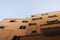 Facade of beige Mediterranean Spanish houses against a clear blue sky