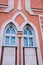 The facade of a brick building with an interesting window design on the Church