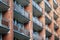 The facade of a brick building with several rows of balconies or loggias.