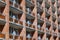 The facade of a brick building with several rows of balconies or loggias