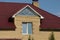 Facade of a brown brick private house with a white window