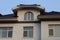 Facade of a brown loft of a private house with tiled roof