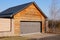 Facade brown wooden garage with closed gate