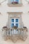 Facade of a building with a balcony and flowers