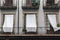 Facade building detail balconies with white curtains in El Born quarter of Barcelona.