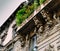 Facade of building in Porta Venezia neighbourhood. Ornamental humanist statues hanging from the wall. Architecture is early 1900s