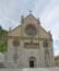 Facade of the Cathedral of Gemona with a statue of side