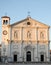 Facade of the church, with three statues, illuminated by the setting sun in Palmanova in Friuli (Italy)