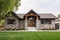 facade of craftsman house with stone walls and wooden doors