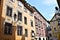 Facade decorated with stuccos of a historic building and blue sky in Graz in a small square.