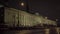 Facade of factory at night. Scene. Appearance of small factory with high windows and chimneys on background of night sky