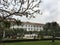 Facade of famous historic Raffles Grand Hotel Dâ€™Angkor building and its park