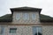 Facade of a gray private brick house with windows