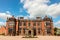 Facade of an historic English mansion in red brick.