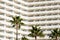 Facade  hotel or apartment building palm trees