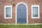 The facade of the house with a blue arched door