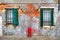 Facade of house with shutters and regged wall in Venice.