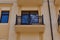 Facade of the house with windows and balconies. Fragment of a facade of a building. Wall of a creamy building with windows.