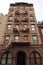 Facade of the late 19th-century multistory apartment building with old retail store in the ground floor, in the South Village, NYC