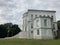 Facade of luxury estate with stairs. From below exterior of luxury mansion with staircase and many windows on sunny