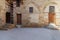 Facade Mamluk era historic building with grunge stone bricks wall and grunge wooden doors, Darb al Ahmar District, Cairo, Egypt