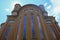 Facade of Monumental cathedral in Modena, Italy, Tempio monumentale ai Caduti di Guerra across the blue sky from beneath