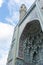 The facade of the mosque and minaret against a blue sky with clouds