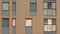 The facade of the new brick high rise apartment building with balconies. Stock footage. Brown brick house with windows.