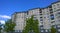 Facade of a new multi-story residential building. Sale and rental of economy class apartments and comfortable housing for young fa