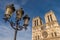 Facade of Notre-Dame Cathedrale and traditionnal parisian lamp p