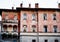 Facade of an old brick building with arched windows in Menaggio. Como, Italy
