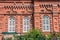 Facade of the old brick building with white window shutters