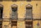 Facade of an old building with balconies and windows very deteriorated