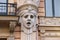 Facade of old building with sculptures - woman heads in Art Nouveau style Jugendstil