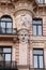 Facade of old building with sculptures - woman heads in Art Nouveau style Jugendstil