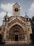 Facade of an old building. Yak Chapel in Budapest. On the facade of the church are carved statues of Jesus Christ and 12