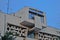 The facade of an old communist building, straight lines and gray concrete