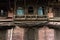 Facade of an old dusty building in Kathmandu decorated with Newari wood carving