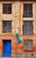 Facade of an old industrial brick house with mermaid, old door and windows. Old town of Stralsund in Germany