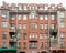 The facade of an old residential building with crumbling plaster. Panorama