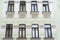 The facade of an old stone building. Windows and decorative stucco figures