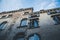 Facade of an old Venetian brick building with an open window and a clear blue sky, Venice, Italy