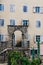 The facade of an ordinary old building with a door and windows in Montenegro.