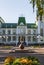 Facade of the Oryol State Institute of Culture building, statue and flowerbed in front of the entrance.