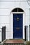 Facade part of residential building with blue door,