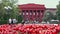 The facade of the red building of Kiev University and flower bed.