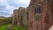 Facade of the ruins of Goodrich Castle in Herefordshire, England under cloudy skies