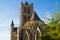 Facade of Saint Nicholas` Church Sint-Niklaaskerk in Ghent, Belgium, Europe, with green tree at the foreground during a sunny