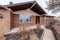 Facade of single storey house with brick wall and walkway in the front yard