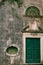 Facade of a stone house in Perast, darkened by time. Montenegro